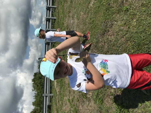 Young girl catches fish