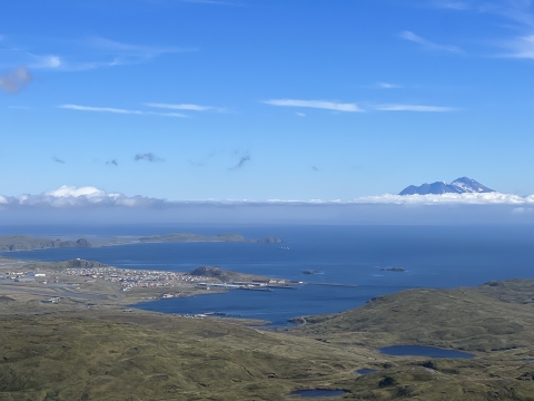 The town of Adak with the island Great Siskin in the background.