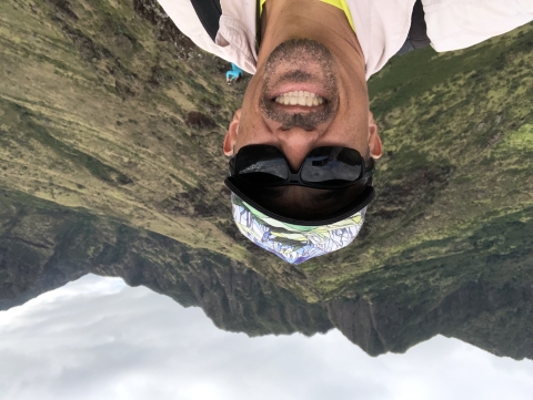 James Kwon takes a selfie with the peaks of the Waianae Mountains in the background.
