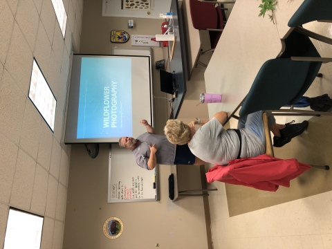 Man giving slideshow presentation in classroom