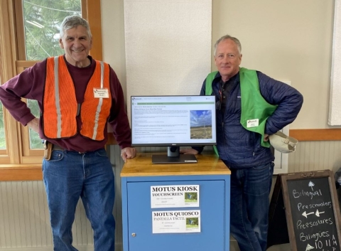 Ankeny National Wildlife Refuge volunteers Pat Allaire (left) and Rich Schramm stand next to the Motus kiosk in the Ankeny Hill Nature Center