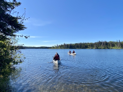 two canoes in a large lake 