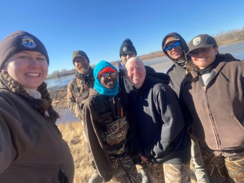 North Dakota Northern Pintail Team smiling in front of a wetland