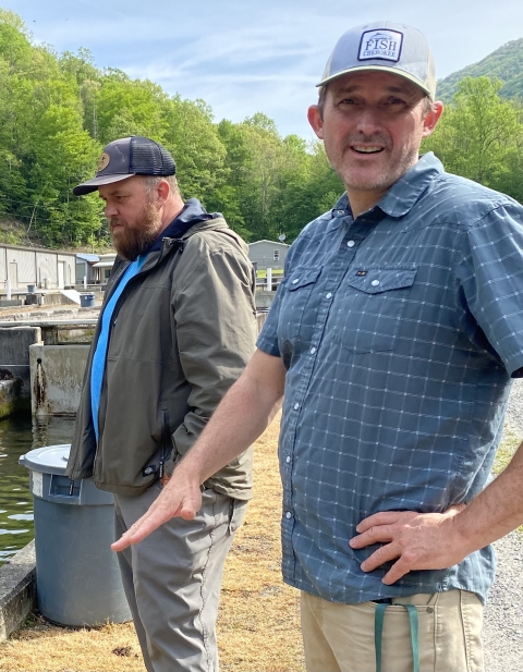 Two men at a fish hatchery.