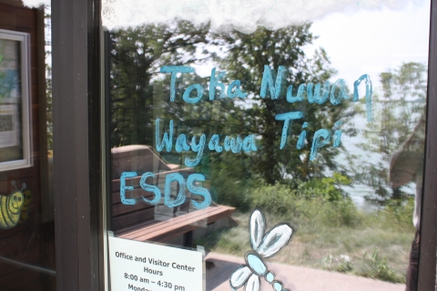 Artwork painted onto the front doors of a visitor center. Words painted read Toka Nuwan Wayawa Tipi ESDS