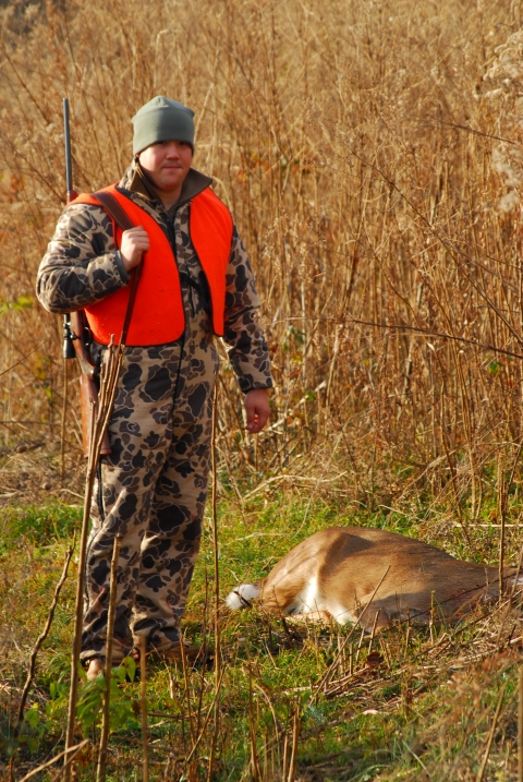 Deer hunter with harvested doe