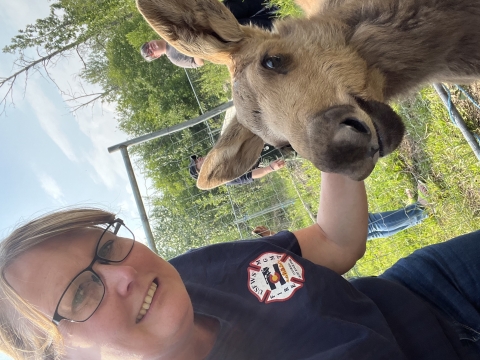 Shawna Martinez takes a selfie with a baby moose at a a animal rescue/sanctuary in Canada.