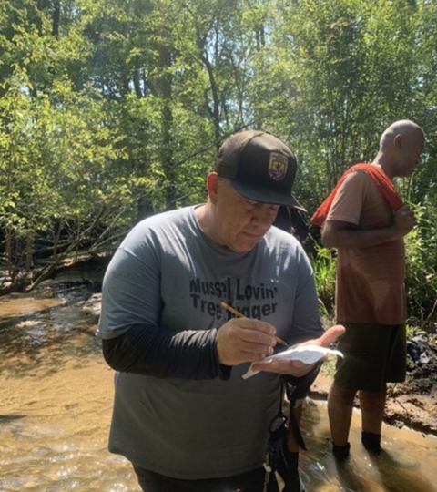 Biologist taking freshwater mussel survey notes
