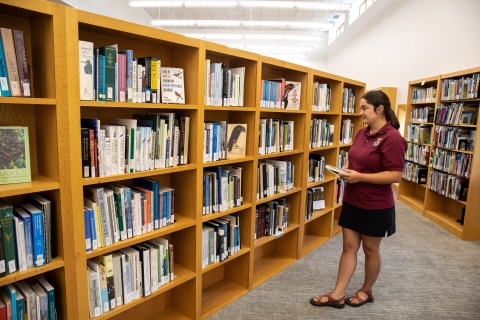 A library user browses the shelves at the USFWS Library