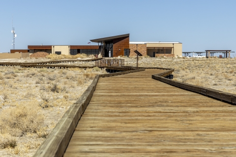 a boardwalk leading up to a large building