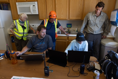 Team members of the Seabird Protection Project monitor the field work through computers. 