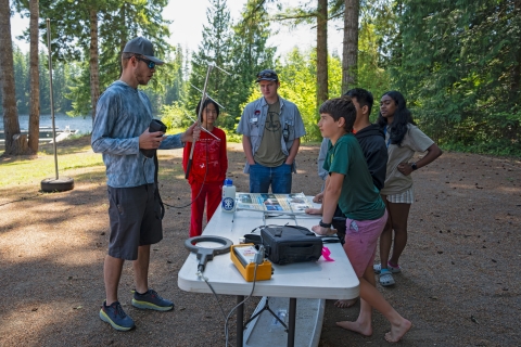 Jakob Bengelink teaching a fisheries science technology lesson around a table outside at the academy.