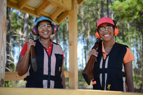 Two women Clay shooters hold their shotguns at Florida Fish and Wildlife Conservation Commission managed range. 