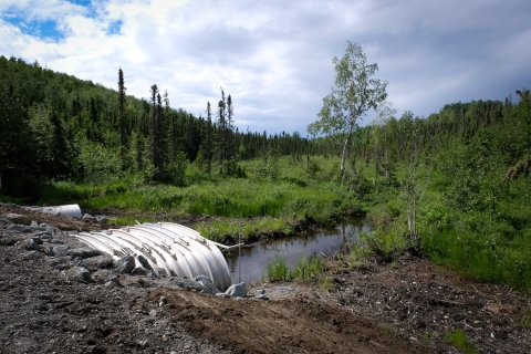 A new culvert extends beneath a road in Wasila, AK, to improve fish passage for salmon.