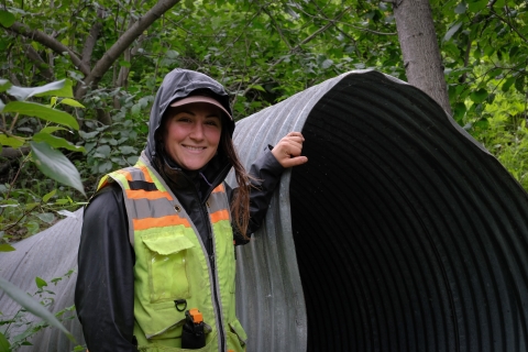 Jess Straub poses with a soon-to-be-removed culvert