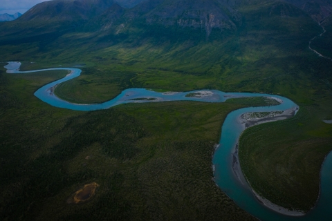 An aerial photo of a vivid blue river bending and twisting across a lush, green landscape near the Coastal Plain.