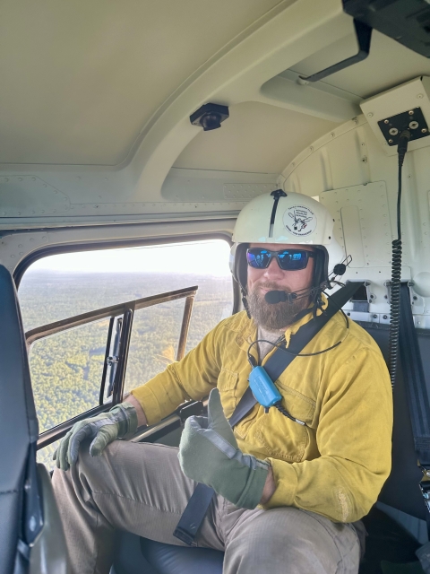 USFWS Firefighter Ron Deroche gives a thumbs up on the back of the helicopter.