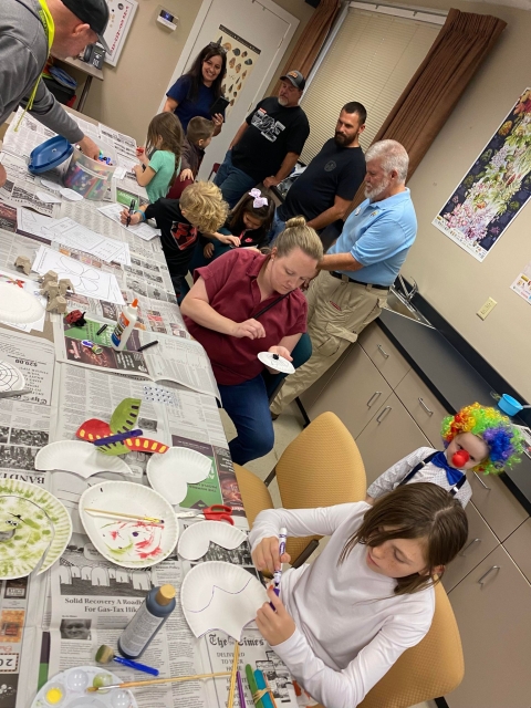 People gathered in classroom making crafts
