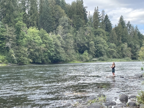 A young woman fishing in Oregon's Clackamas River