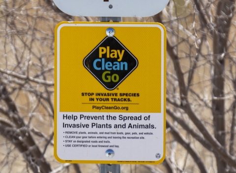 sign saying play clean go stop invasive species in your tracks