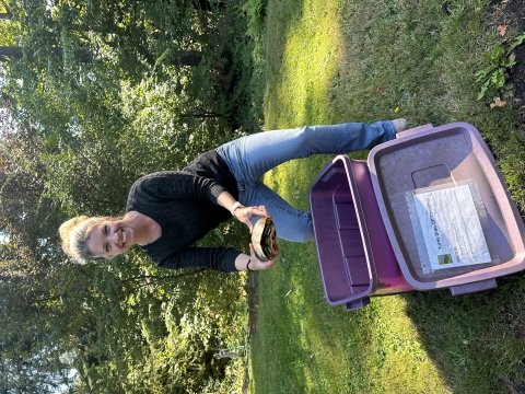 A staff member with the Oregon Department of Fish and Wildlife holding an invasive red-eared slider turtle