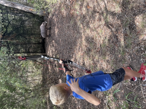 5th grade student shooting a boar at the 3D archery course at Inks Dam NFH.