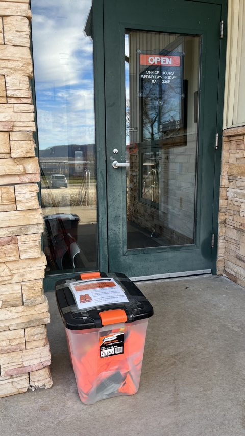 Black box in front of the contact station door with orange vest inside