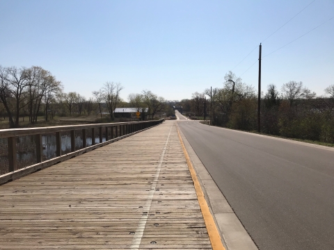 A pedestrian bridge leads across a highway to another refuge unit.