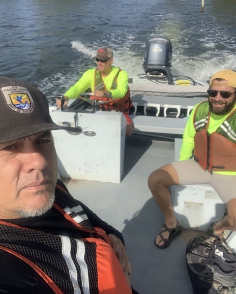 USFWS biologists driving on boat