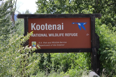A brown sign with white text that reads "Kootenai National Wildlife Refuge"