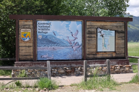 A large sign featuring a mural with ducks and a map