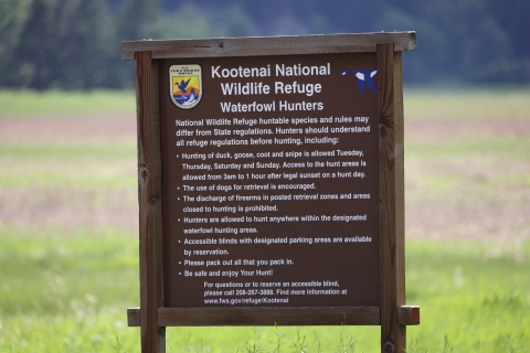 A brown sign with white text