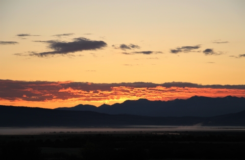 A red sunrise with mountain background.
