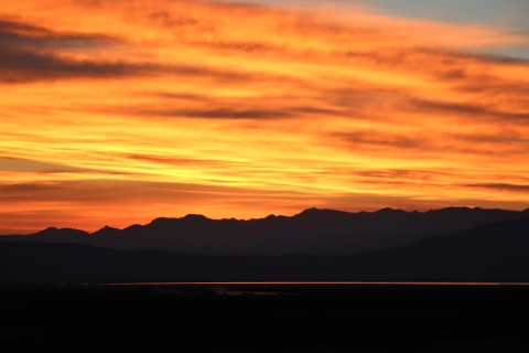 A red sunrise with mountain background.