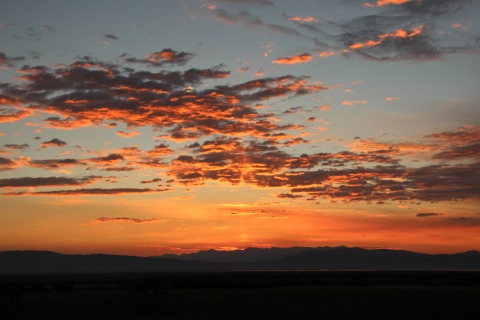 A red sunrise with mountain background.
