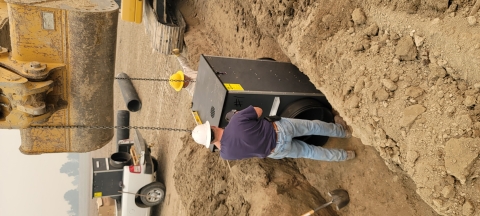 Volunteers install a culvert into a ditch