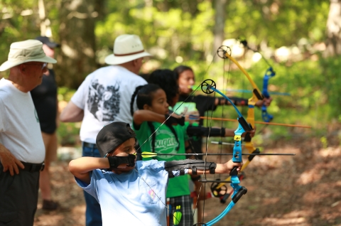 Mystic Summer Tribal camp practicing archery