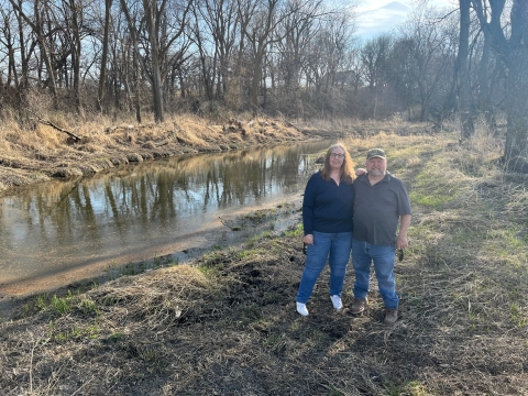 Kathy and Dave Law stand in front of the restored oxbow on their land