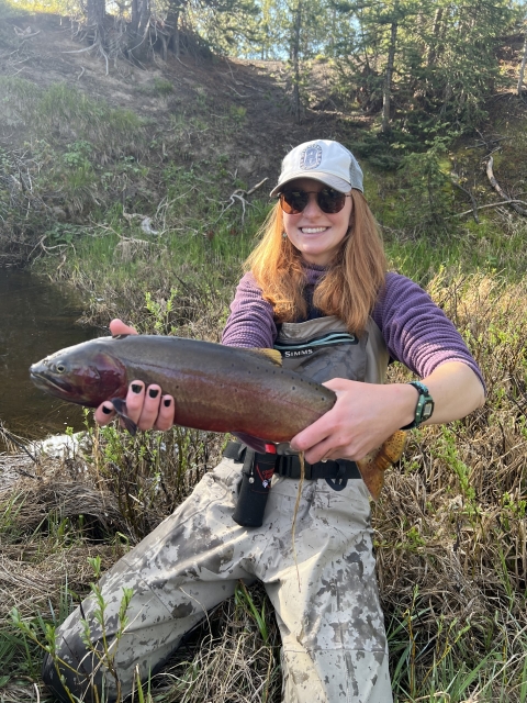 Woman holding cutthroat trout 