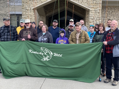 Anglers posing with Kentucky Wild banner