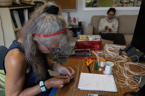  Duck team members hand-making harnesses for Laysan duck transmitters