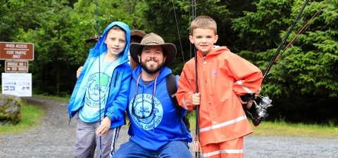 volunteer camp instructor matt thomas with 2 young anglers kodiak nwr