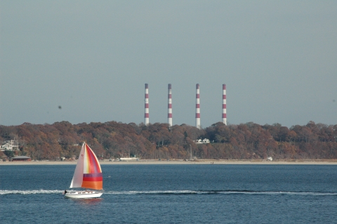 A colorful sailboat catches a breeze offshore of the refuge