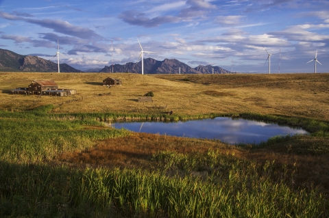 Landscape photo of Rocky Flats showing a pond, Lindsay Ranch, and the flatirons