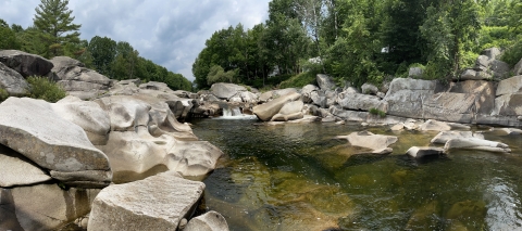 Sandy River in Maine with small falls and large boulders.