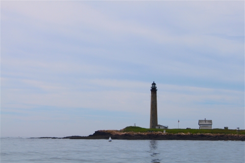 Island with lighthouse and out building