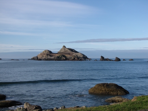 View of a rocky island from the seashore