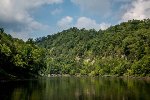 Body of water surrounded by forested hills