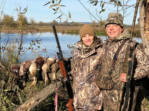 Man and woman waterfowl hunting