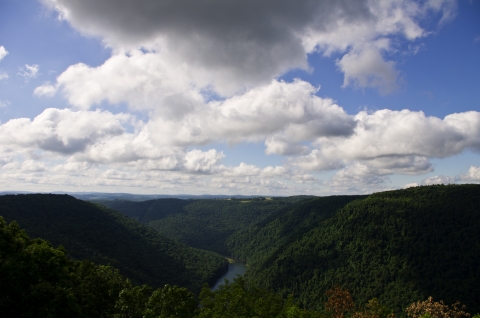 A mountain top view of a river flowing through a valley